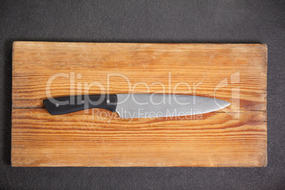 Knife on wooden board