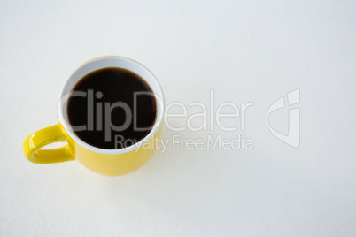 Black coffee served in yellow cup