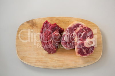 Sirloin chop and beef steak on wooden tray