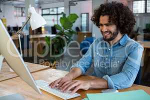 Male graphic designer working at desk