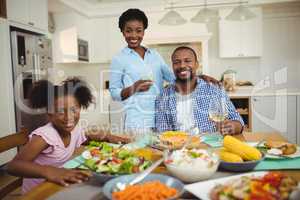 Portrait of family having meal on dinning table at home