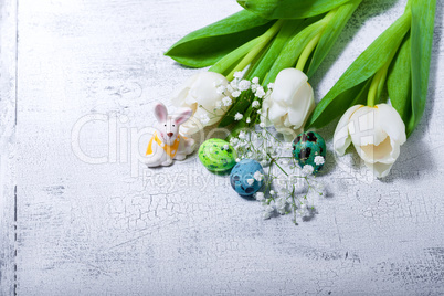 Bunny, eggs and white flowers Easter symbols