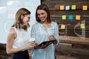 Business executives discussing over digital tablet