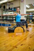 Beautiful woman exercising on arc barrel