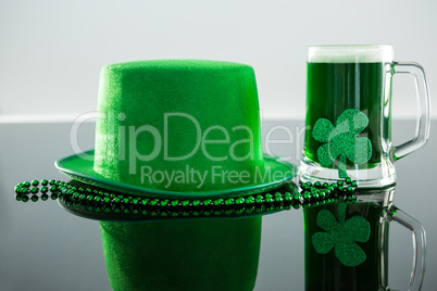 St Patricks Day green beer with shamrock, leprechaun hat and bead