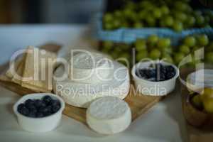 Variety of cheese and blue berry on counter