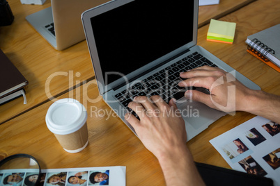 Man typing on laptop at desk