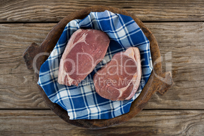 Sirloin chop on wooden tray against wooden background