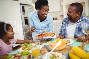 Happy woman serving food to the family