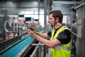 Factory worker using a digital tablet in factory