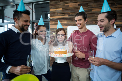 Businesspeople celebrating their colleagues birthday