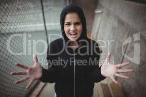 Angry teenage girl standing at school campus