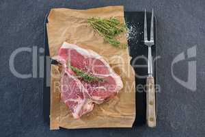 Sirloin chop and fork on slate plate