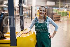 Female factory worker standing at drinks production factory