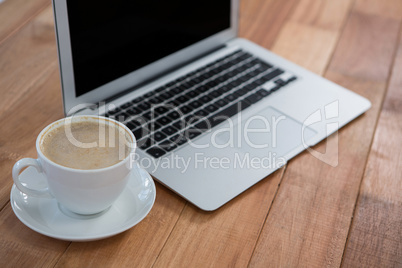 Cup of coffee and laptop