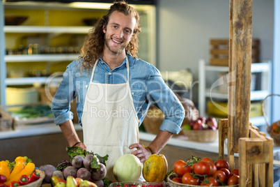 Vendor standing at the counter with hands on hips