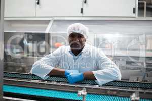 Factory engineer leaning on production line