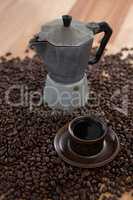 Coffeemaker with coffee beans and coffee mug