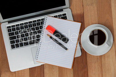 Cup of coffee with laptop, organizer, maker and pen