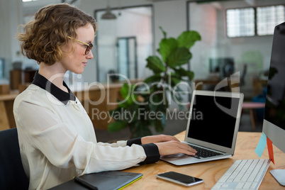 Female graphic designer working at desk