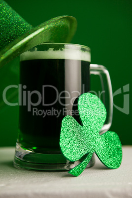 St Patricks Day leprechaun hat with mug of green beer and shamrock