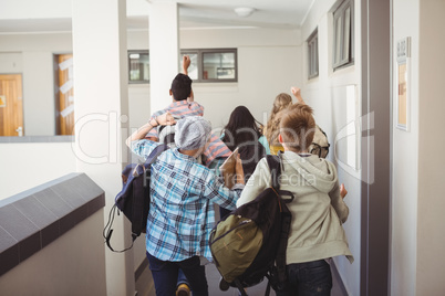 Group of classmate running in corridor