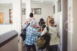 Group of classmate running in corridor