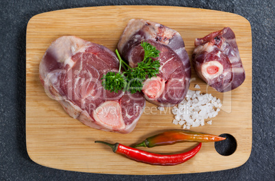 Sirloin chop, salt and chili on wooden board