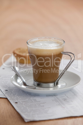 Coffee cup with saucer, spoon and documents