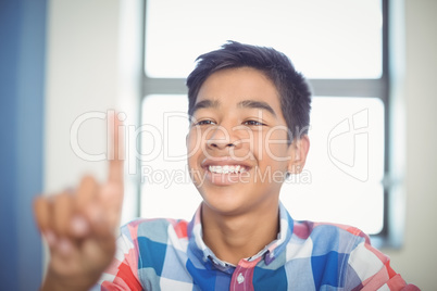 Schoolboy raising hand in classroom Schoolboy raising hand in classroom