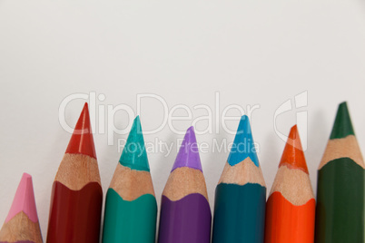 Close-up of colored pencils arranged in a row