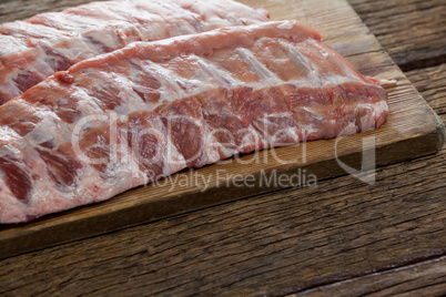 Beef ribs on wooden board