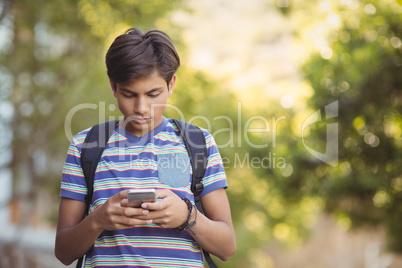 Schoolboy using mobile phone in campus