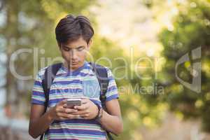 Schoolboy using mobile phone in campus
