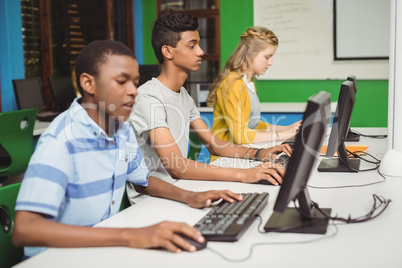 Students studying in computer classroom