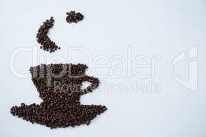 Coffee beans forming cup and saucer shape