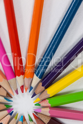 Close-up of colored pencils arranged in a circle