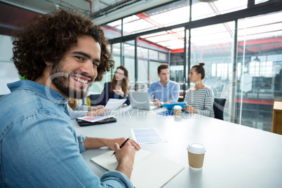 Portrait of smiling business executive in a meeting