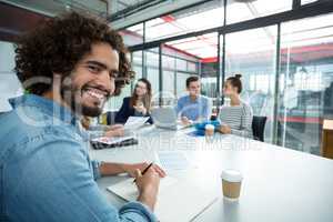 Portrait of smiling business executive in a meeting