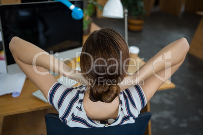 Female graphic designer relaxing on chair