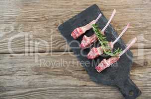 Rib chops and rosemary herb on slate board