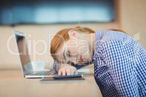 Female graphic designer sleeping on desk