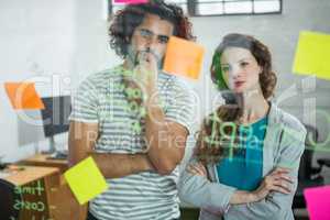 Thoughtful executives looking at sticky note