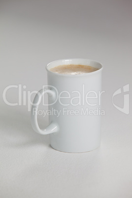 White mug of coffee with creamy froth