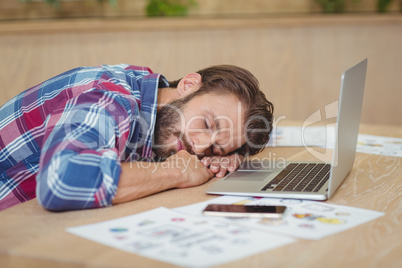 Tired business executive sleeping on desk while working