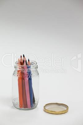 Colored pencils kept in a glass jar