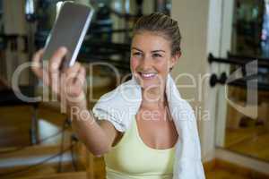 Beautiful fit woman taking selfie on mobile phone after workout