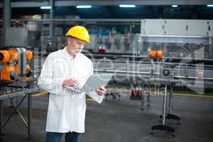 Factory engineer using laptop in the factory