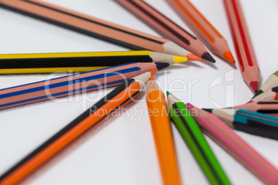Close-up of colored pencils arranged in a circle