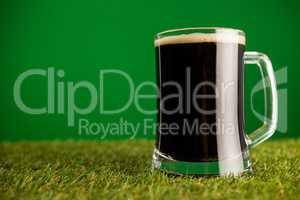 Mug of green beer on grass for St Patricks Day